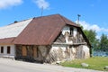 Tiny old very small abandoned attached suburban family house made from wood and clay natural materials with boarded windows Royalty Free Stock Photo