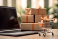 Tiny orange color shopping cart, parcels boxes and laptop computer with blurred background, delivery service, e-commerce, online