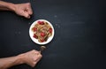 Tiny pancake cereal - trendy quarantine food. Brutal male hands with fork near bowl with mini pancakes, fresh raspberries and