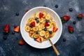 Tiny pancakes for breakfast. Pancakes with strawberries and blueberries cooked in the morning for breakfast in the home kitchen. Royalty Free Stock Photo