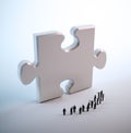 Tiny people looking at a puzzle Royalty Free Stock Photo