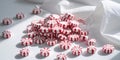 Tiny peppermints in red and white stripes on white. Royalty Free Stock Photo