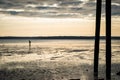 Tiny person walking on the beach at low tide just before sunset. Royalty Free Stock Photo