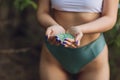 Tiny pieces of plastic collected from sandy beach in hands of environmentalist. Microplastic is polluting the sea and Royalty Free Stock Photo