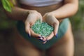 Tiny pieces of plastic collected from sandy beach in hands of environmentalist. Microplastic is polluting the sea and Royalty Free Stock Photo