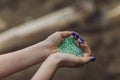 Tiny pieces of plastic collected from sandy beach in hands of environmentalist. Microplastic is polluting the sea and Royalty Free Stock Photo