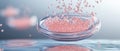 Tiny pink particles falling into glass bowl with water creating future life Royalty Free Stock Photo
