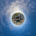 tiny planet in blue sky with clouds in city center near modern skyscrapers. Transformation of spherical 360 panorama in abstract Royalty Free Stock Photo