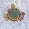 tiny planet in blue sky with clouds in city center near modern skyscrapers. Transformation of spherical 360 panorama in abstract Royalty Free Stock Photo