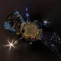 Tiny planet in night sky in city center near modern skyscrapers or office buildings. Transformation of spherical 360 panorama in Royalty Free Stock Photo