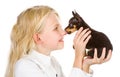 The tiny puppy kisses the girl on a nose. Royalty Free Stock Photo