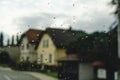 Tiny raindrops on the glass. Blurred houses of the small neighborhood by the highway in Poland seen through the front window glass Royalty Free Stock Photo