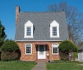 Tiny Red Brick House with Steep Hip Roof Royalty Free Stock Photo