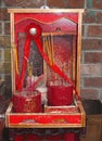 Tiny red Buddhist altar with incense sticks