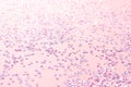 Tiny silver crystal confetti on a pink background.
