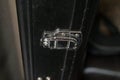 A tiny silver hinge holding together a guitar case.