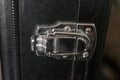 A tiny silver hinge holding together a guitar case. Royalty Free Stock Photo