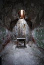 Tiny stool in an abandoned prison cell Royalty Free Stock Photo