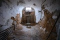 Tiny stool in an abandoned prison cell Royalty Free Stock Photo