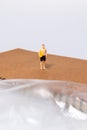 Tiny Surfer on Notebook Near Plastic Sheet Royalty Free Stock Photo