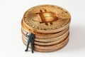 Tiny thinking businessman figurine while leaning to shiny bitcoin stack on white background Royalty Free Stock Photo