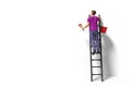 Toy miniature figurine character with ladder and red paint in front of a wall Royalty Free Stock Photo