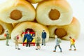 Tiny toys businessman and Sausage bread.Concept food background.