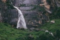 Tiny traveler figure near the Yogini waterfall in Indian Himalaya Royalty Free Stock Photo