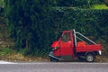 Tiny vintage, oldschool car in green vivid background, typical italian colors