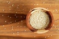 Tiny white sesame seeds in small wooden bowl, view from above Royalty Free Stock Photo