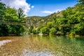 Tiny wooden and cable bridge above crystal clear water in river Neretva in village Ladanica, Bosnia and Herzegovina Royalty Free Stock Photo