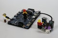 Miniature IT workers diagnosing computer board problem