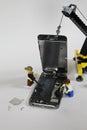 Miniature IT workers repairing a Cell Phone