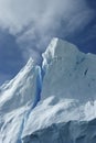 Tip of an iceberg against a blue sky Antarctic summer. Royalty Free Stock Photo