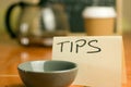 Tip jar in cafe with coffee background Royalty Free Stock Photo