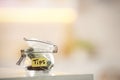 Tip jar with money on table against blurred background, space for text Royalty Free Stock Photo