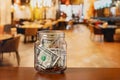 Tip jar in restaurant dining room.