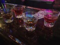 Tip money on bar with shots of liquor Royalty Free Stock Photo