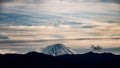 The tip of Mt. Fuji rising above the surrounding mountains