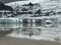 Tip of SÃÂ³lheimajÃÂ¶kull glacier in south of Iceland, with alternating layers of white and light-blue ice and black soil Royalty Free Stock Photo