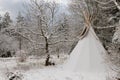 A tipi covered in snow in winter