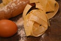 Tipical italian pasta pappardelle freh food homemade with eggs on table and kitchen utensils