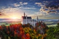 Tipical postcard. Majestic Neuschwanstein castle during sunset, with colorful clouds under sunlight. Dramatik Picturesque scene.