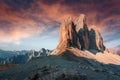 Tipical postcard. Majestic Tre peaks di Lavaredo during sunset, with colorful clouds under sunlight. Dramatic Picturesque scene.