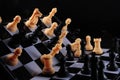 Tipped chessboard with scattered pieces creating a dynamic chaotic scene