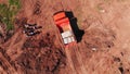 Loaded tipper truck stands by workers at construction site