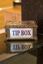 Tipping box is on the counter of the hotel`s recipes. Hotel in Turkey. Grateful tourists leave small bills and coins for hote