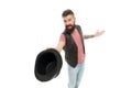 Tipping his hat as a salutation. Cheerful man greeting with hat. Bearded hipster in casual attire holding classic black