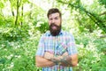 Tipping a wink. Caucasian man on summer landscape. Bearded man with unshaven beard hair on caucasian face. Caucasian