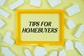 Tips For Homebuyers text with house models on yellow background Royalty Free Stock Photo